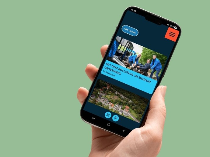 Eine Hand hält ein Smartphone, darauf eine geöffnete App.